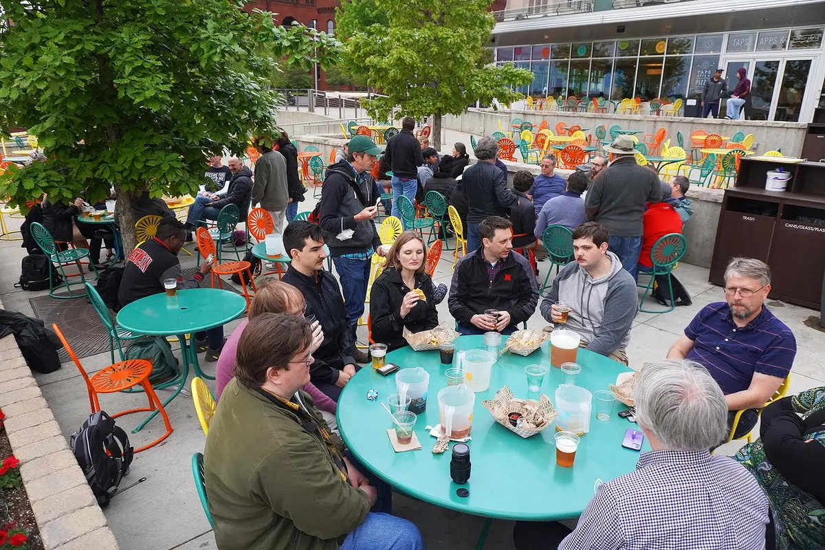 HTCondor Week attendees gathered around a large table at the terrace